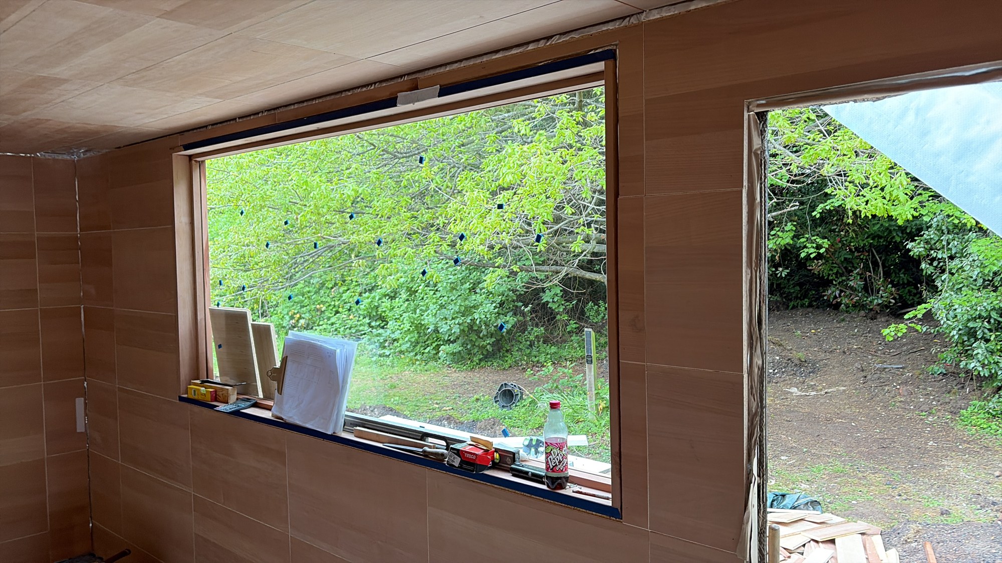 Window opening surrounded by timber cladding