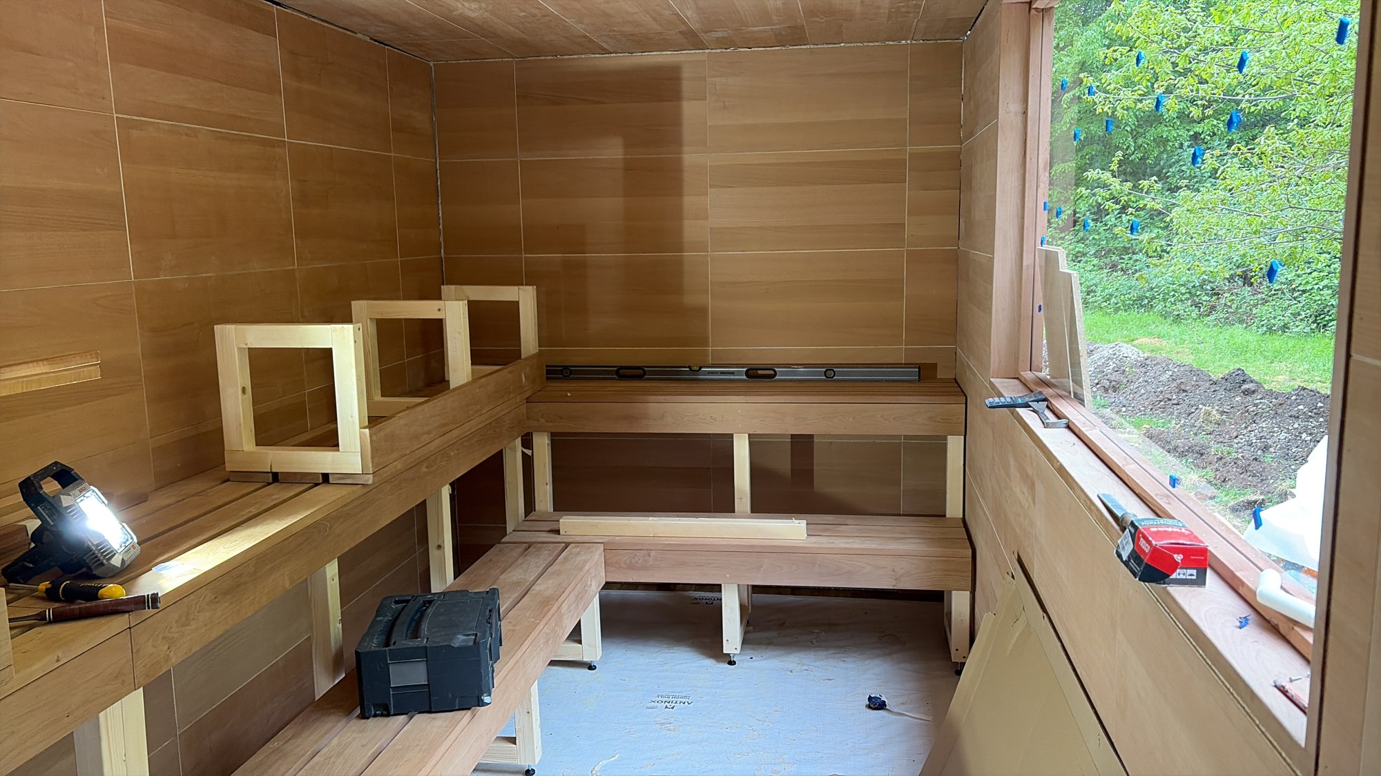 Bench assembly inside a timber-lined sauna